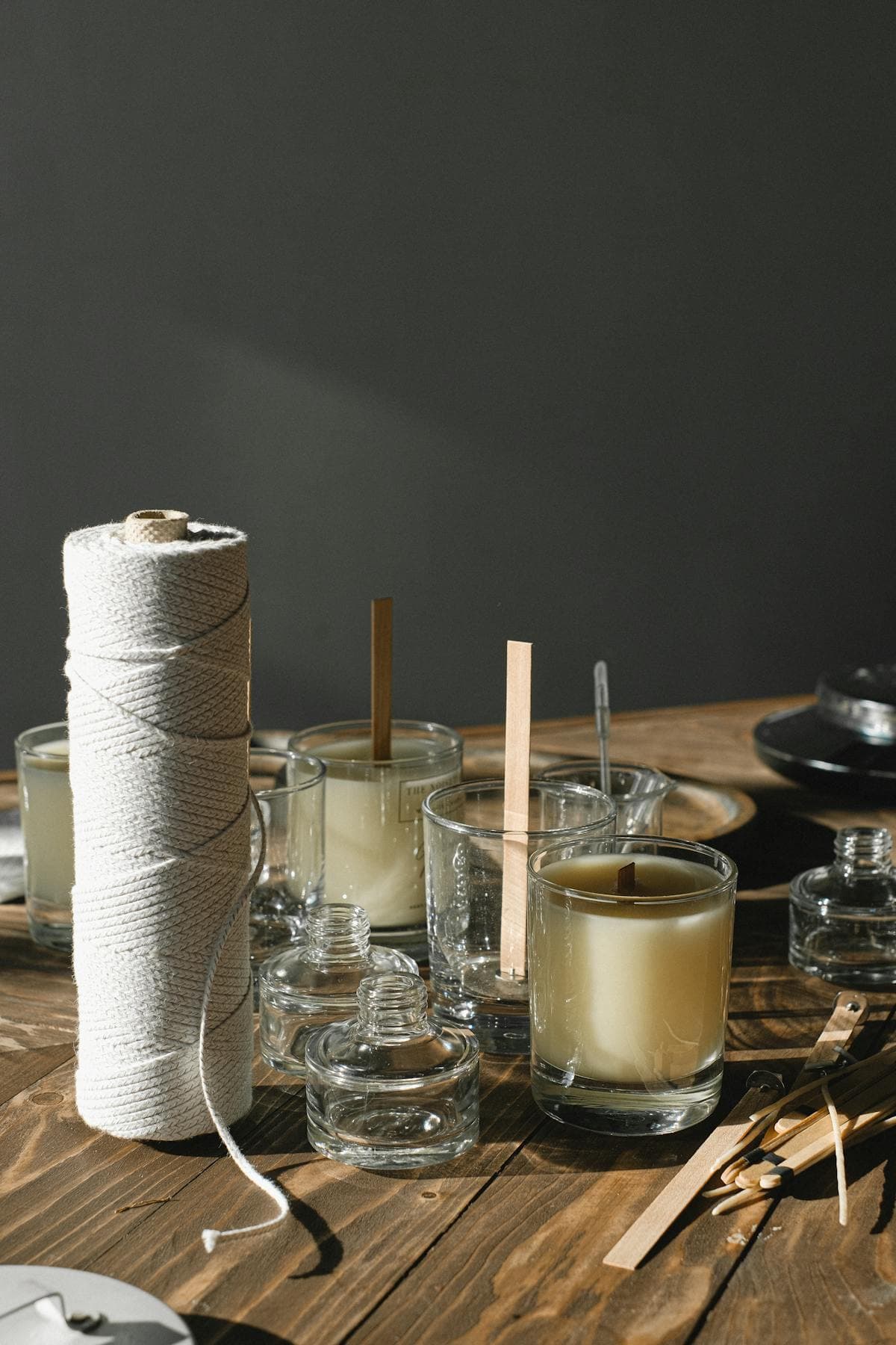 Candle making supplies laid out on a workbench — wax, wicks, fragrance oils and containers for UK candle makers