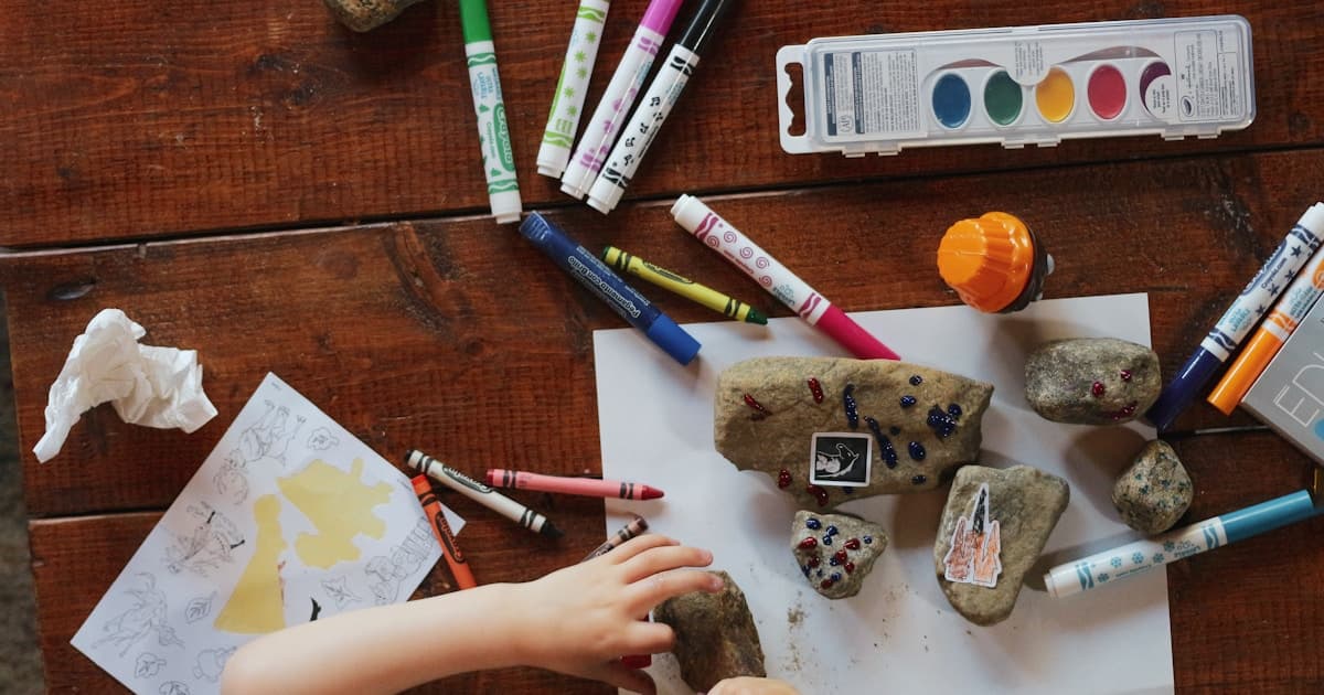 Assortment of fragrance oil bottles for candle making with testing strips and a perfumer's organ in the background