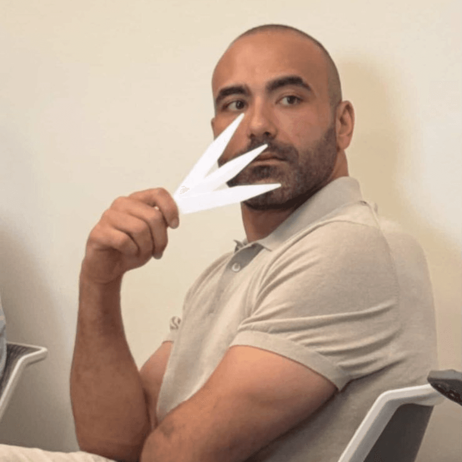 Ahmed Al Hassoni evaluating fragrance on a perfume strip — graduated perfumer Dubai