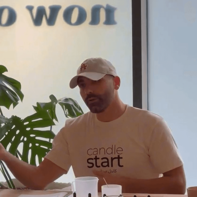 Ahmed Al Hassoni explaining candle making techniques in his Dubai workshop